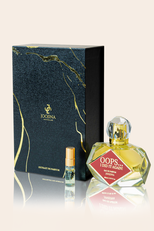 JOOJINA Oops… I Did It Again! beside its black and gold gift box, with the 3 ml trial sample